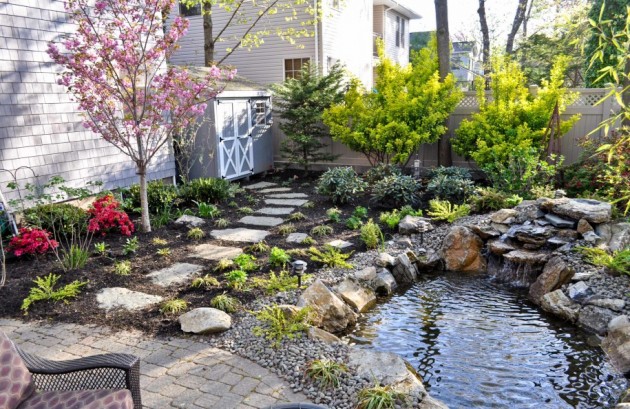 traditional-landscape-ideas-with-pond-design-and-water-feature-also-landscape-rocks-plus-stone-path-and-garden-fences-plus-patio-furniture-beautified-with-ornamental-tree-915x595