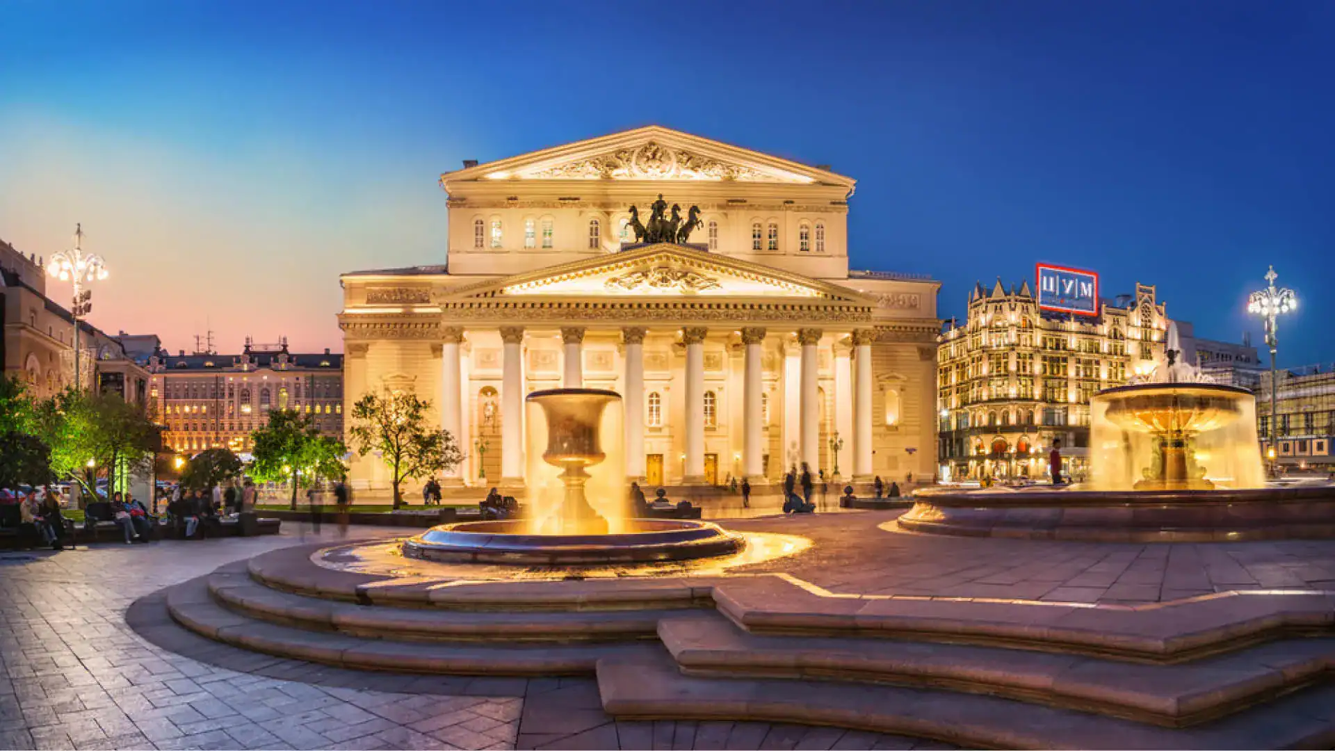 The Bolshoi Theatre in Moscow with neoclassical façade, columns, and grand portico under evening light