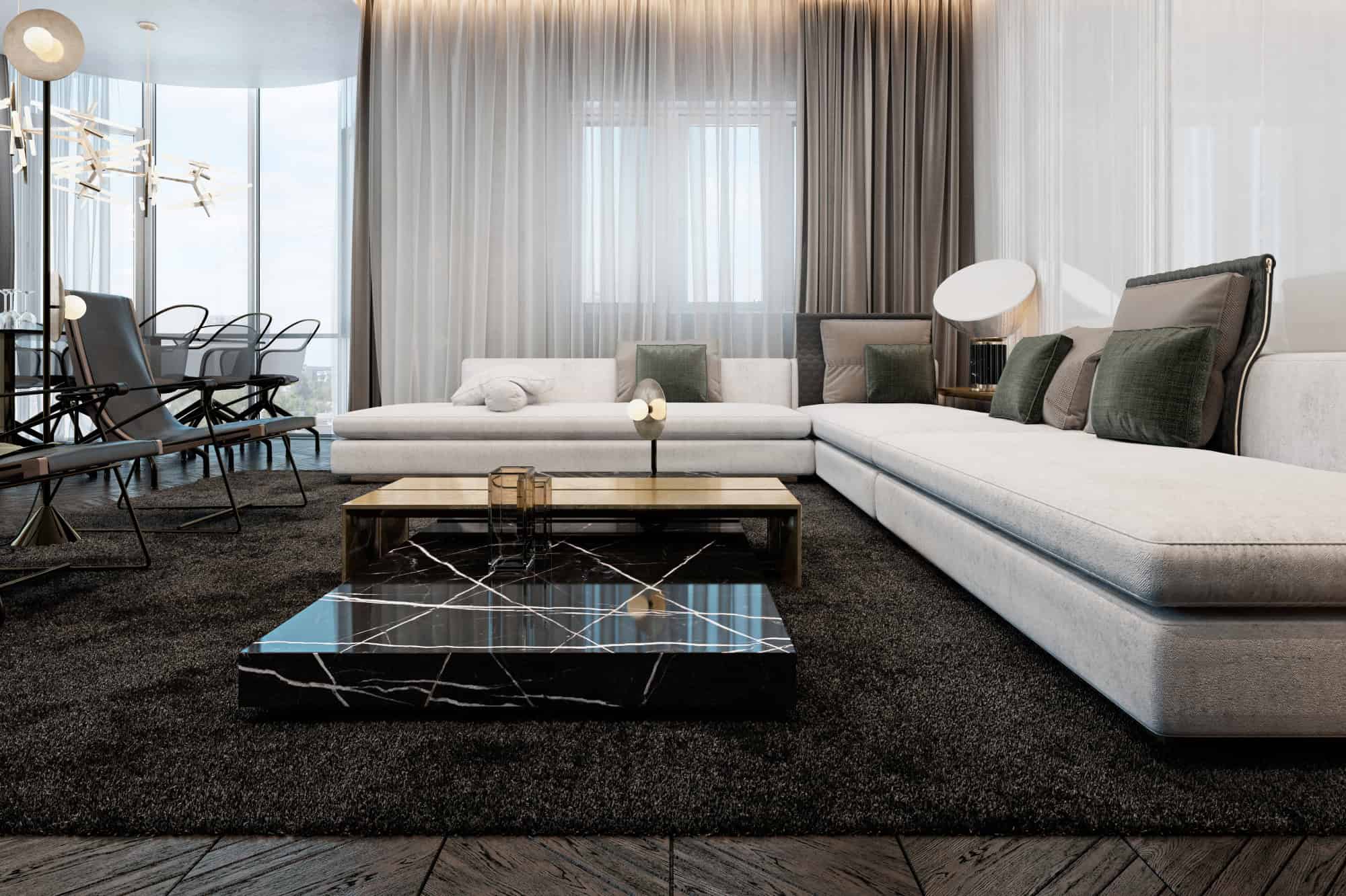 Luxurious modern living room with white sectional sofa, elegant black marble coffee table, and contemporary decor, showcasing sophisticated interior design and stylish furniture.