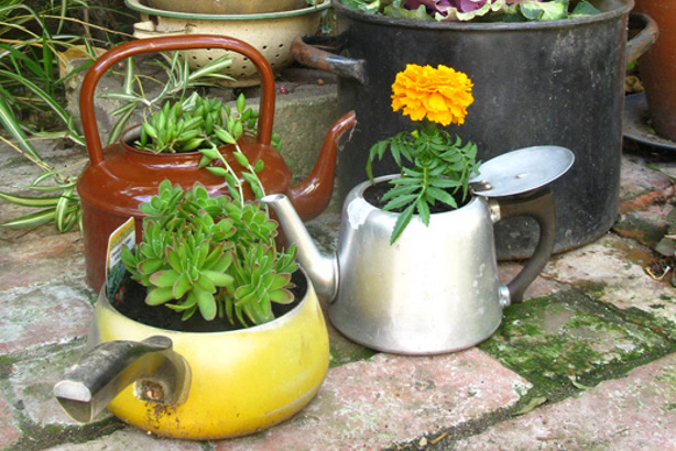 15 Really Cool Ways To Repurpose Old Kitchenware Into Beautiful Planters