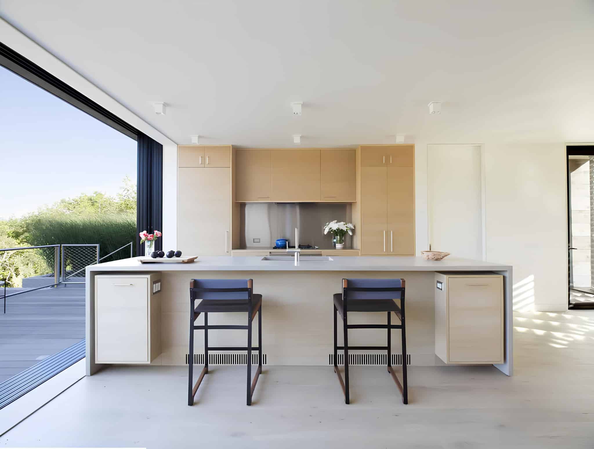 Clean Kitchen Island Light Wood Cabinets Bright modern kitchen with island and light wood cabinetry.