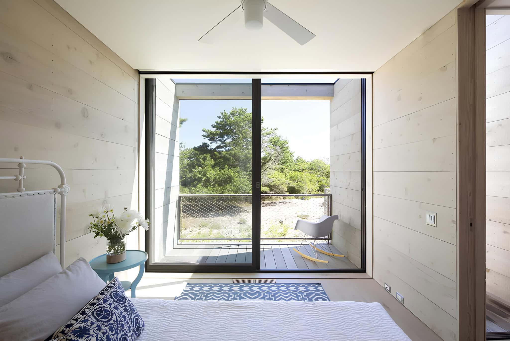 Minimalist Bedroom Balcony Nature View Minimalist bedroom with balcony and view of natural landscape.