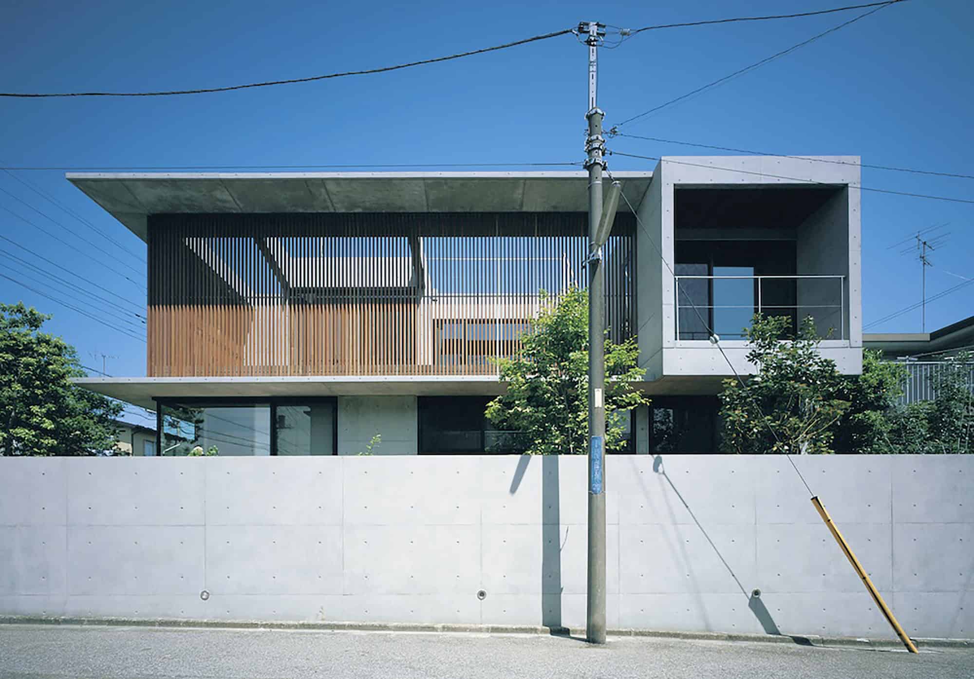 Contemporary modern house with minimalist architectural design featuring clean lines, concrete and wooden elements, and large windows. Ideal for modern architecture art designs and urban residential aesthetics.