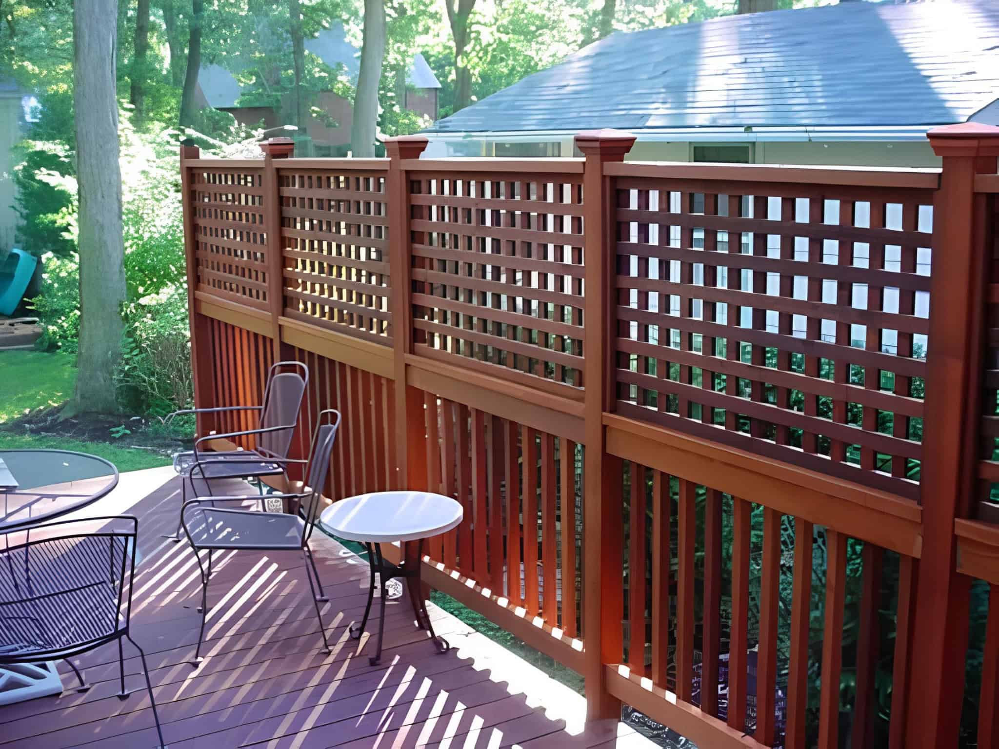 Tall privacy lattice panels on an elevated wooden deck with outdoor chairs