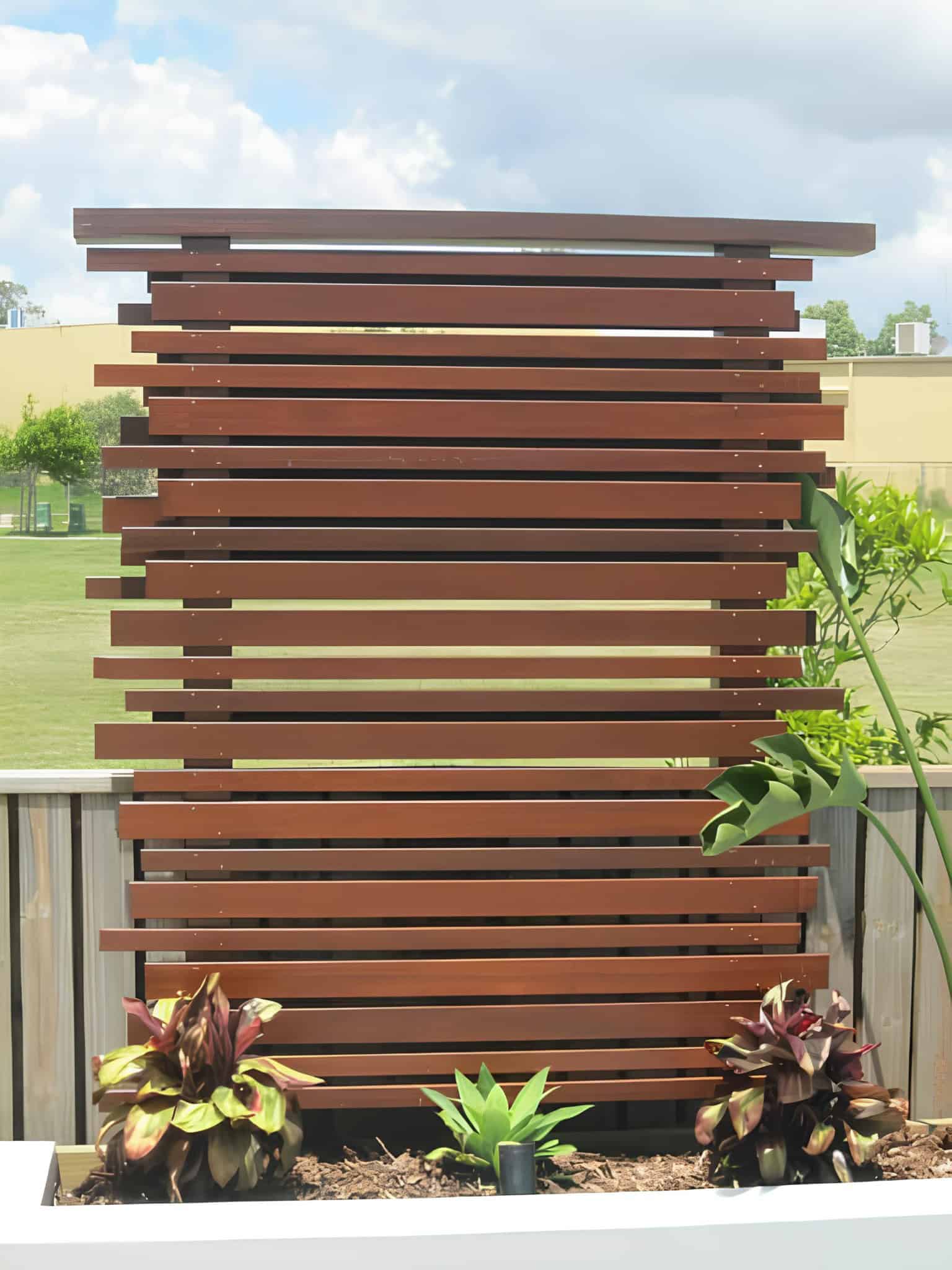 Horizontal wooden slats forming a stylish privacy screen on a modern deck