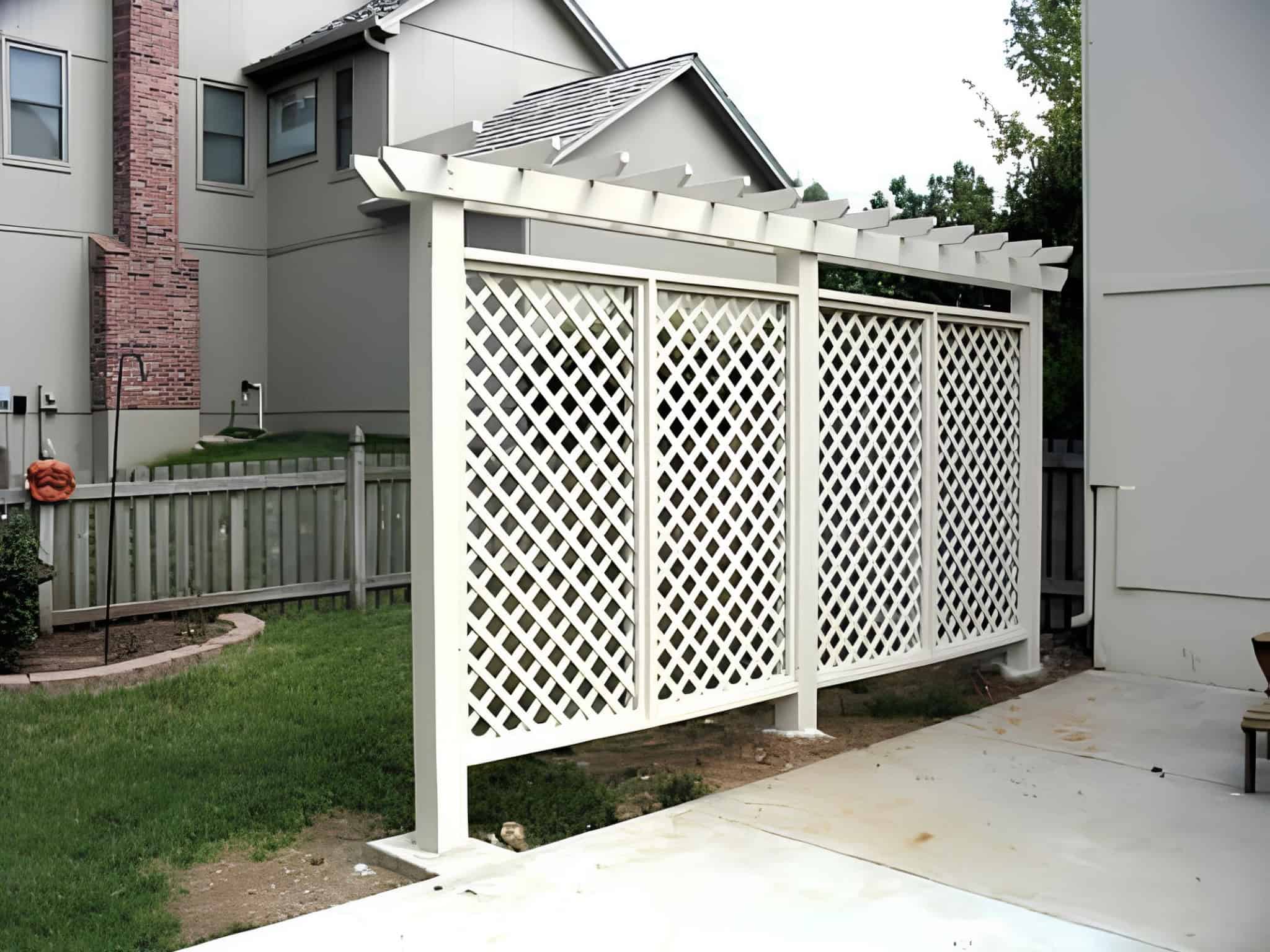 White lattice privacy panels with pergola top in a suburban backyard