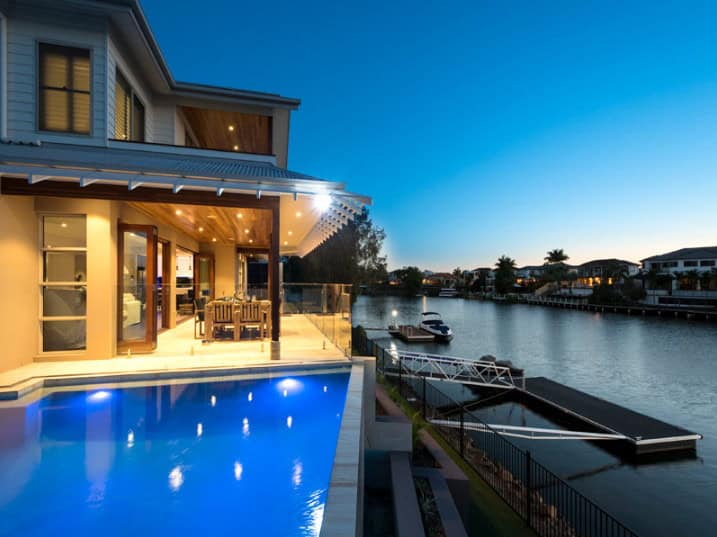 Luxury waterfront home with modern architecture, outdoor pool, and scenic water views, perfect for stylish riverfront living and exclusive residential design.
