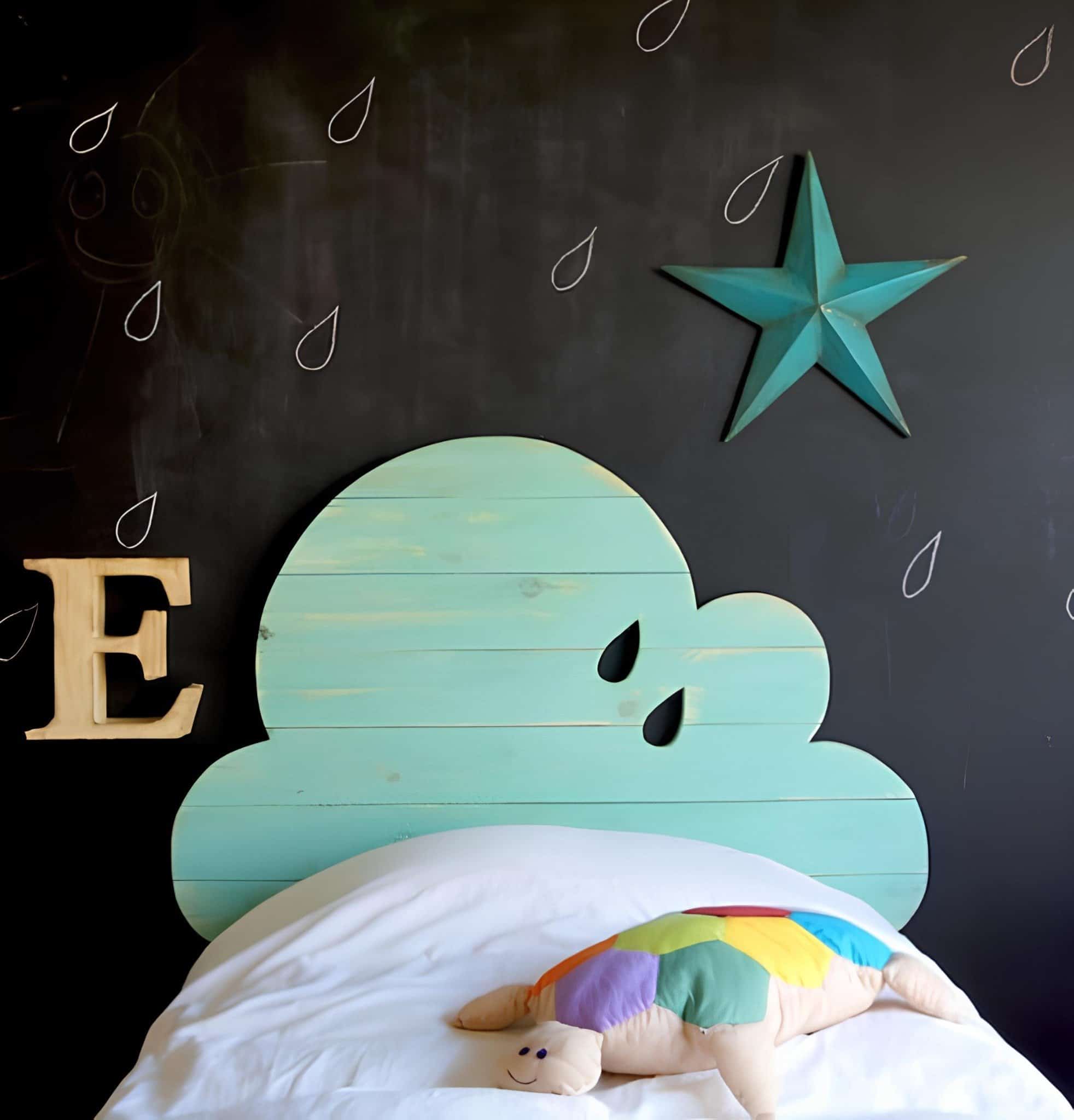 Turquoise cloud-shaped headboard with raindrop accents on chalkboard wall