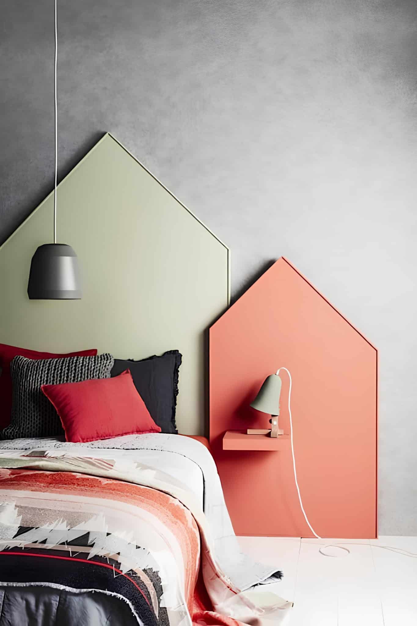 Stylish teenage bedroom with bold house-shaped headboards and modern pendant lighting.