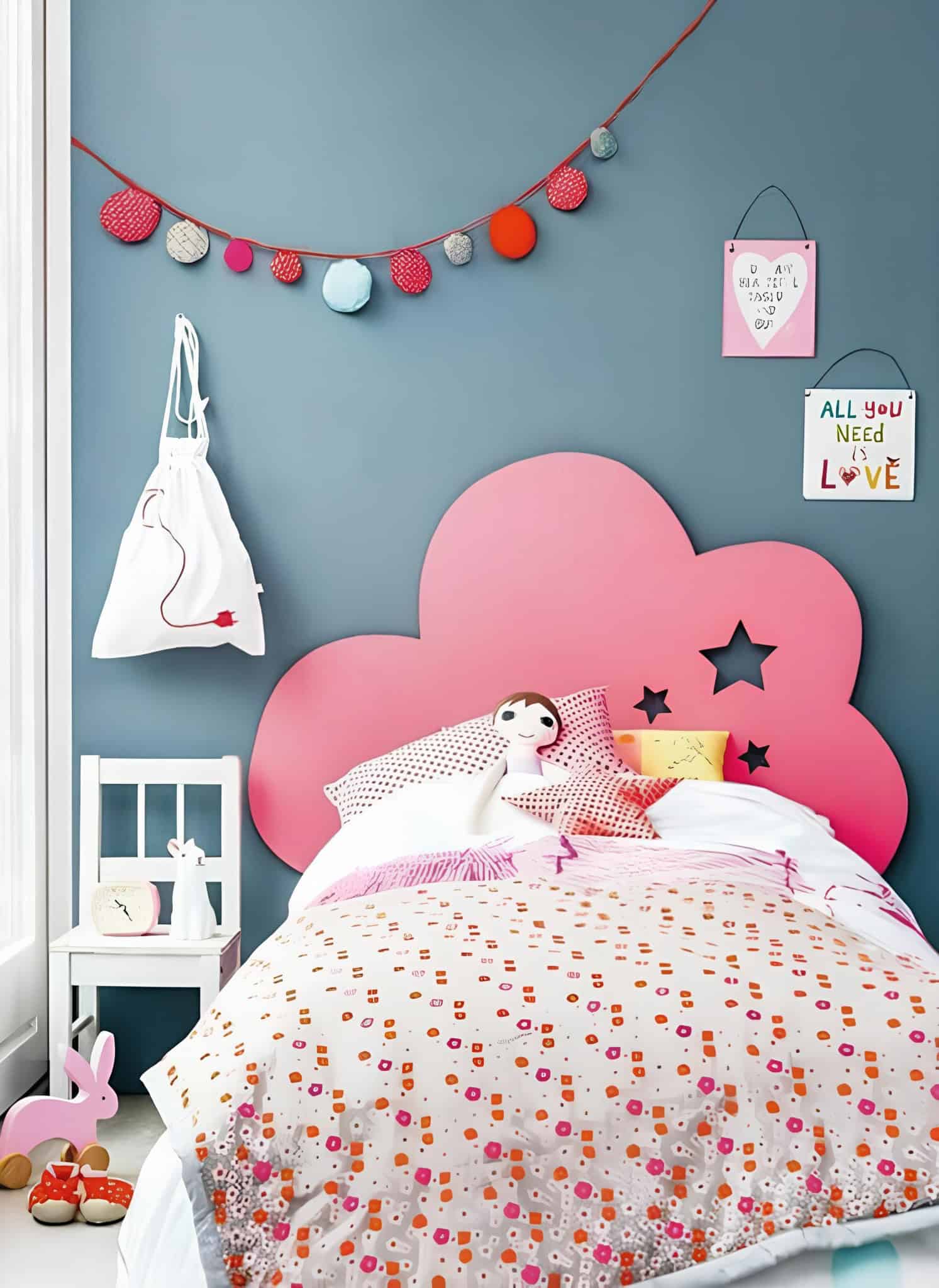 Playful and charming girls bedroom featuring a pink cloud-shaped headboard and colorful decorations.