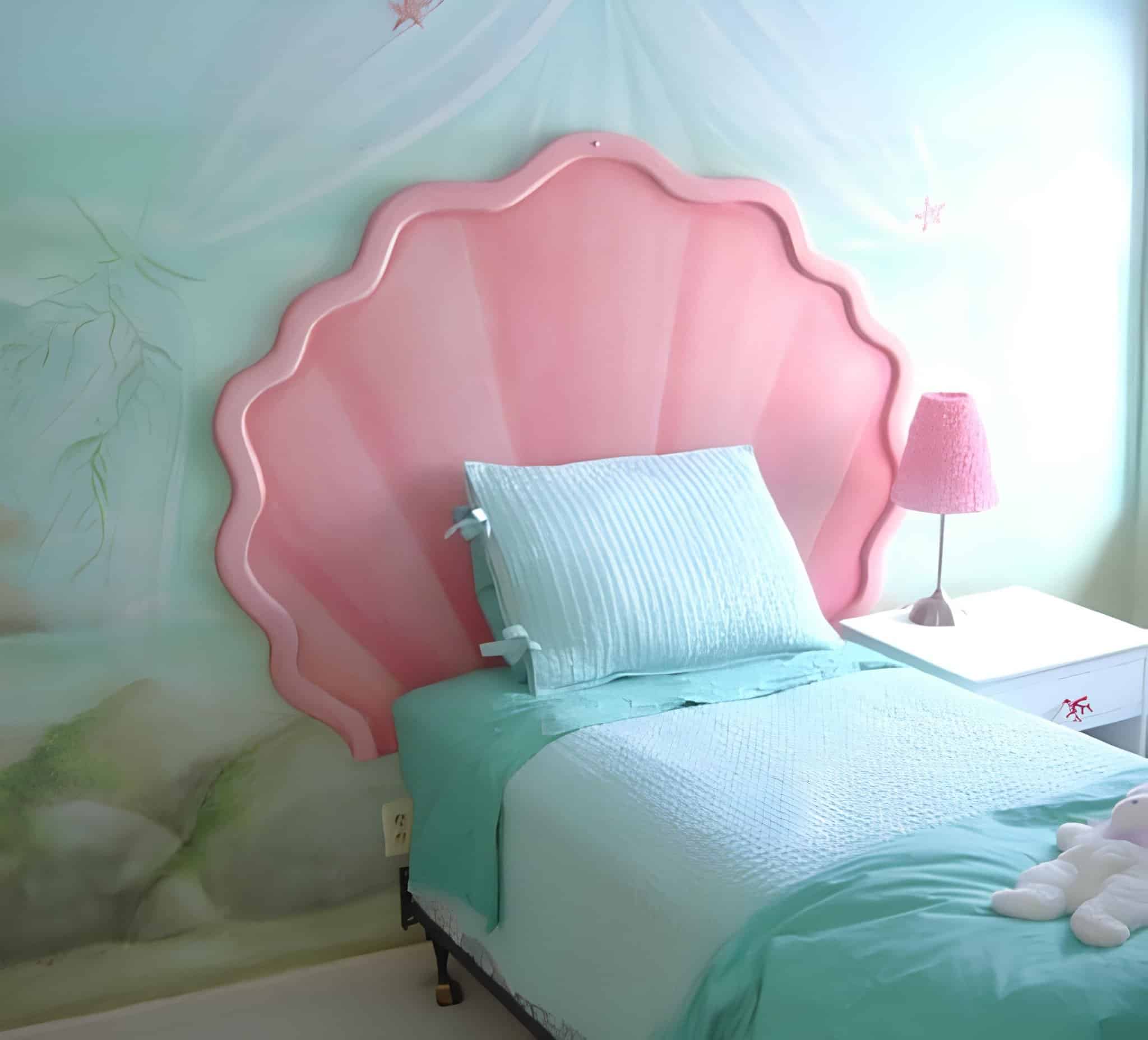 Pink seashell-shaped headboard in a pastel under-the-sea theme room