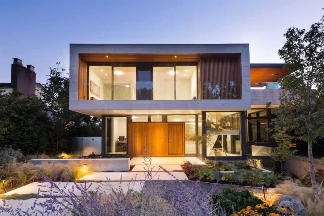 Modern luxury house exterior with contemporary architectural design, large glass windows, and sleek geometric shapes, surrounded by landscaped garden and outdoor lighting.
