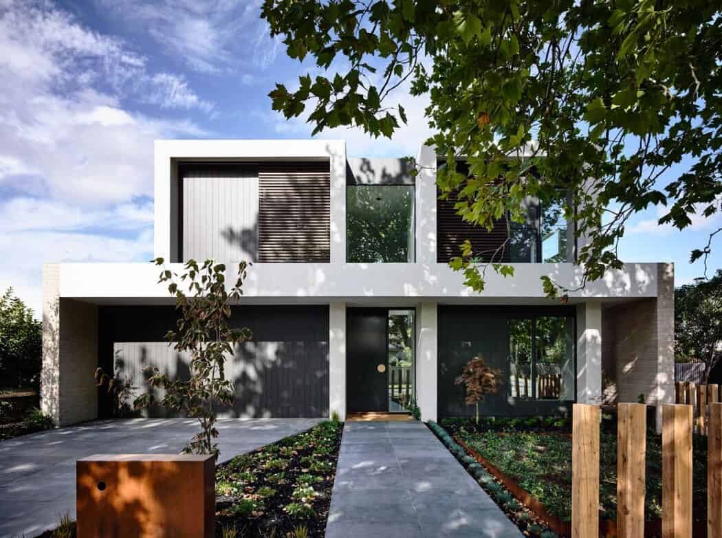 Modern minimalist house with sleek architectural design and clean lines, surrounded by greenery and landscaping, showcasing contemporary architectural art and innovative design elements.