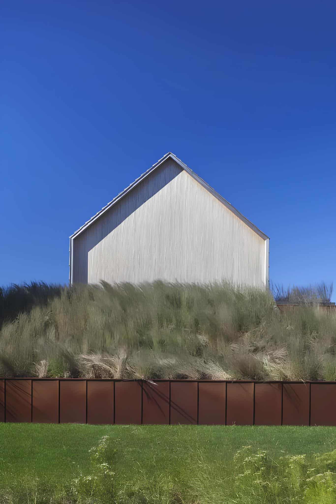 Poolside View and Wood Facade View of wooden gabled house and landscaped path leading to the pool.