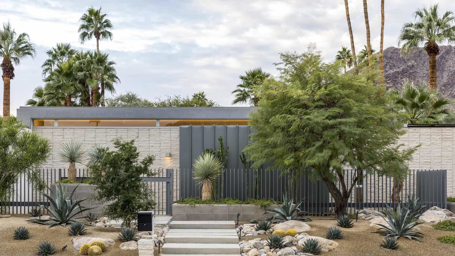 Contemporary desert-style home with minimalist architecture, modern landscaping, and drought-tolerant plants, blending sleek design with natural desert environment.