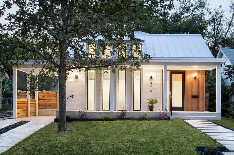 Modern minimalist house with sleek design, large windows, and well-maintained lawn showcasing contemporary architecture and innovative home design.