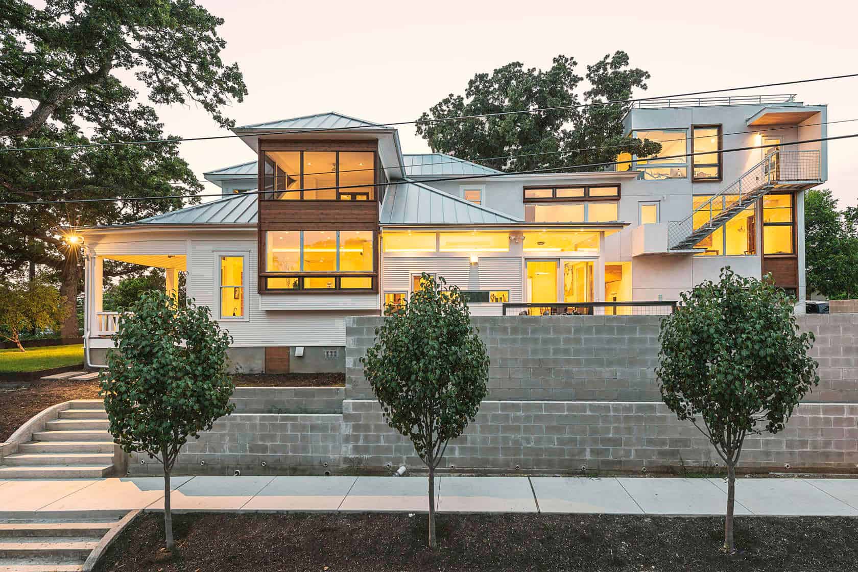 Modern contemporary house with large windows, sleek design, and mixed materials showcasing innovative architecture and stylish home exterior design.