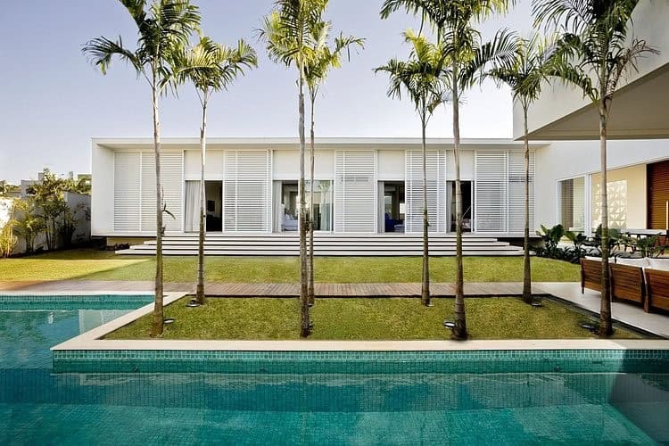 Modern luxury house with swimming pool, tropical landscaping, and contemporary design elements, showcasing innovative architecture and stylish outdoor living space.