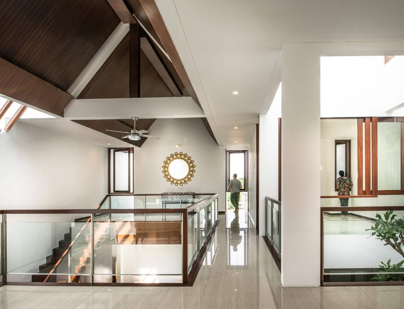 Modern interior of a contemporary home with high ceilings, large windows, and sleek design featuring wood accents, glass railings, and minimalist decor for luxury architecture art designs.
