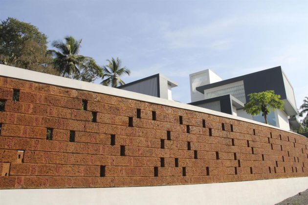 The Running Wall Residence by LIJO RENY Architects in Thalassery, India