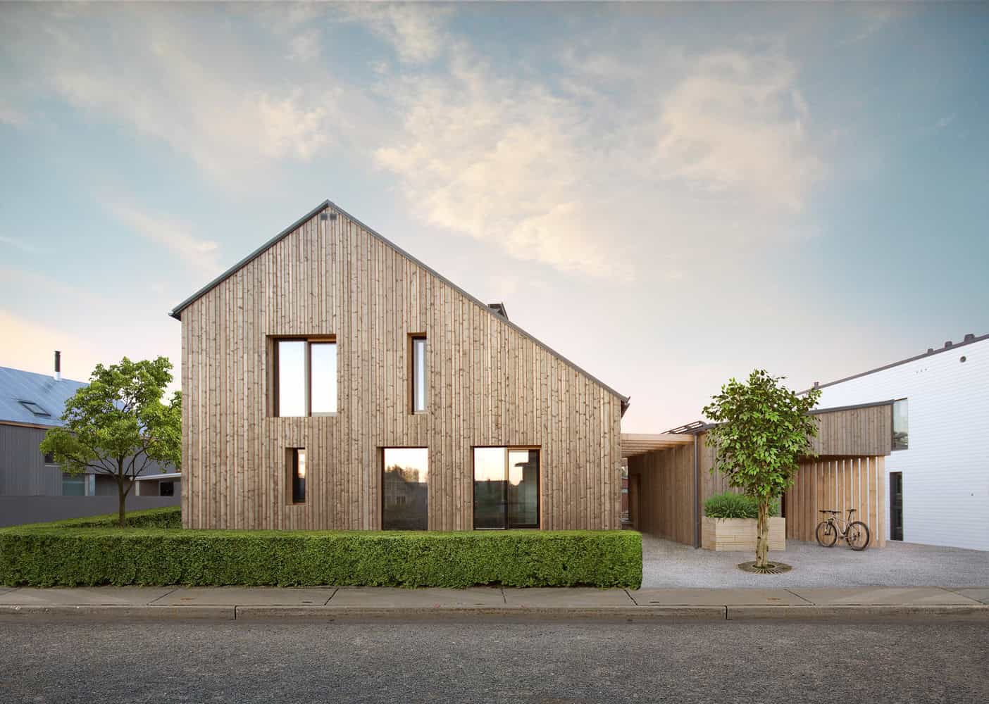 Contemporary minimalist wooden house with a sloped roof, large windows, and modern design complemented by greenery and bicycles, exemplifying innovative architecture and sustainable home design.