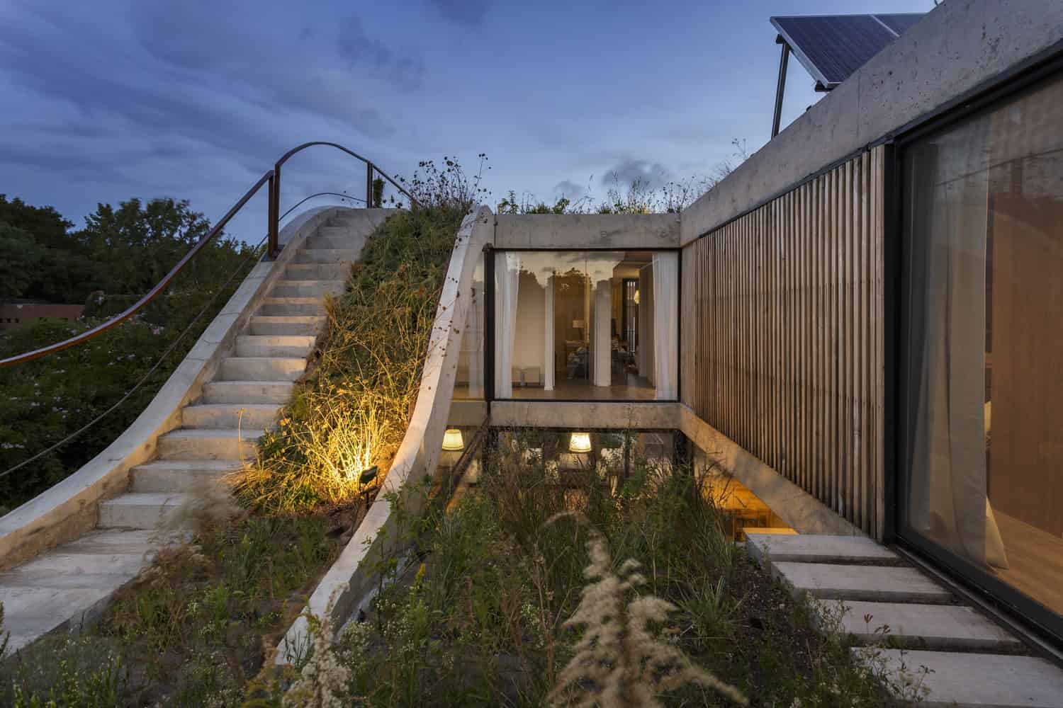 Modern eco-friendly house with rooftop garden and innovative concrete design showcasing contemporary architecture art and sustainable building materials.