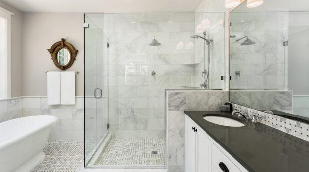 Beautiful master bathroom with shower, bathtub, and sink,  with high end furnishings, lights on
