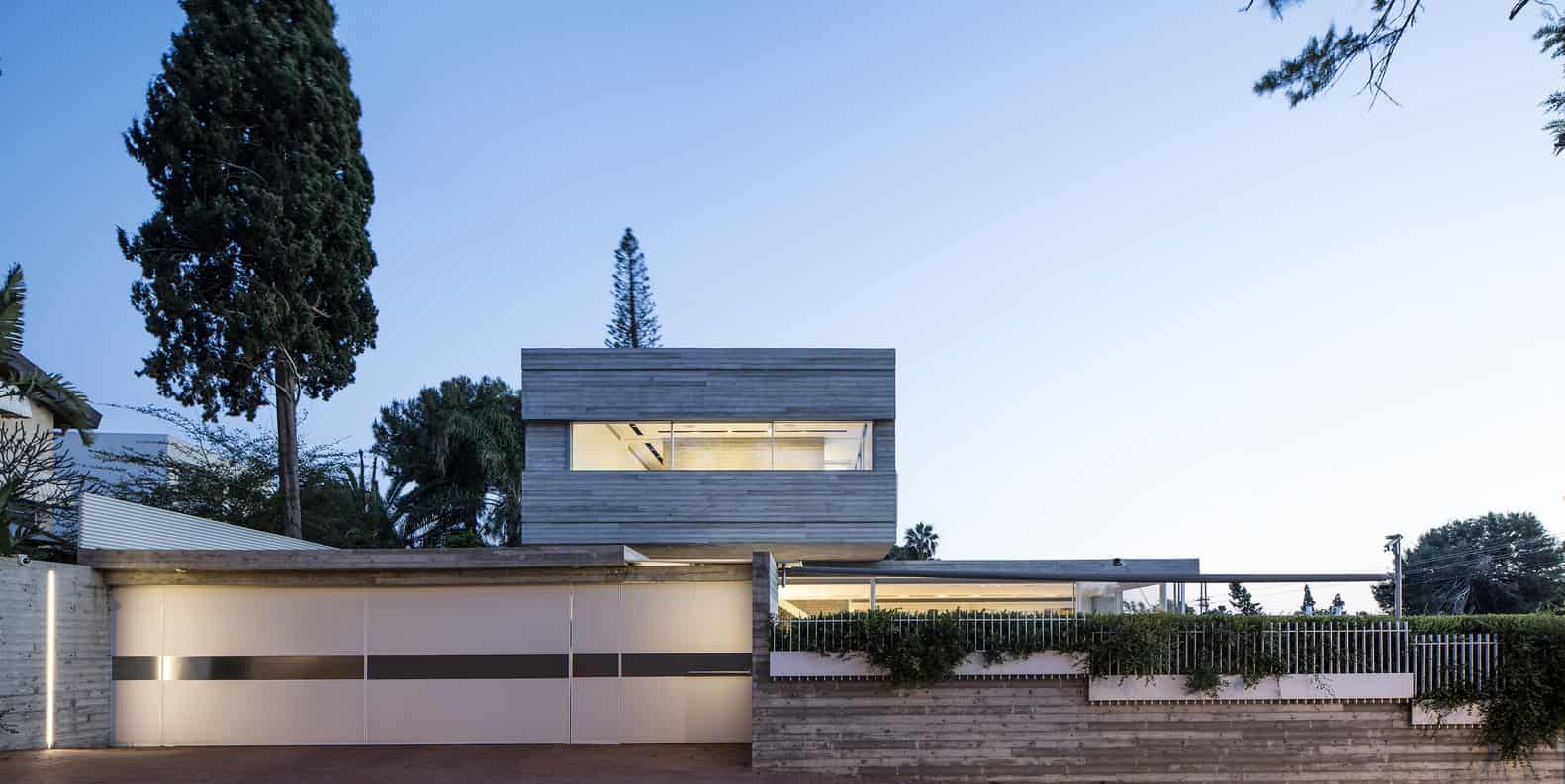 Modern minimalist house with sleek wooden exterior, large windows, and contemporary garden design, reflecting innovative architecture and stylish residential architecture trends.