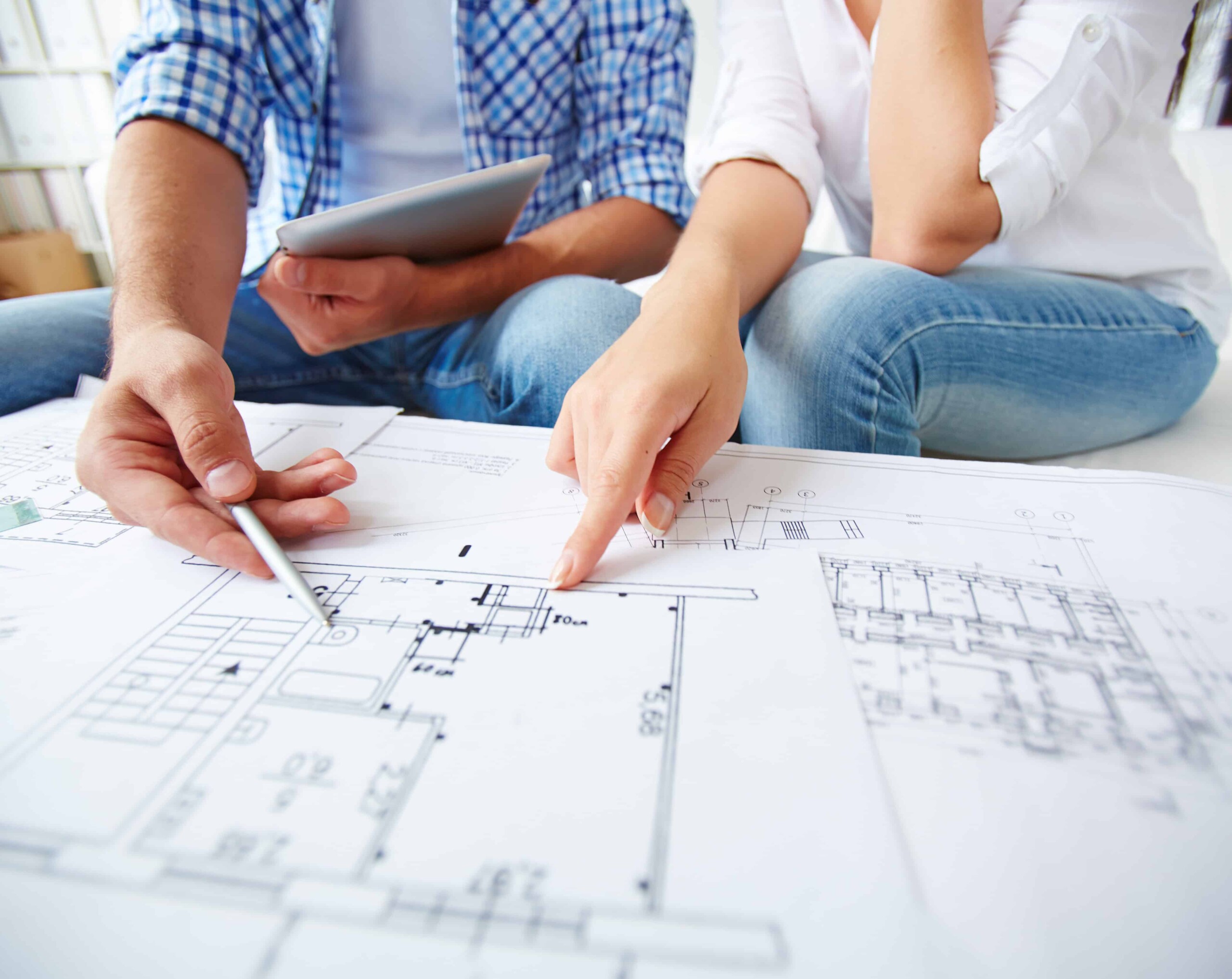 Blueprint consultation for modern architecture design, architectural planning process, professional architects discussing building plans, architectural blueprint review, innovative building design ideas.