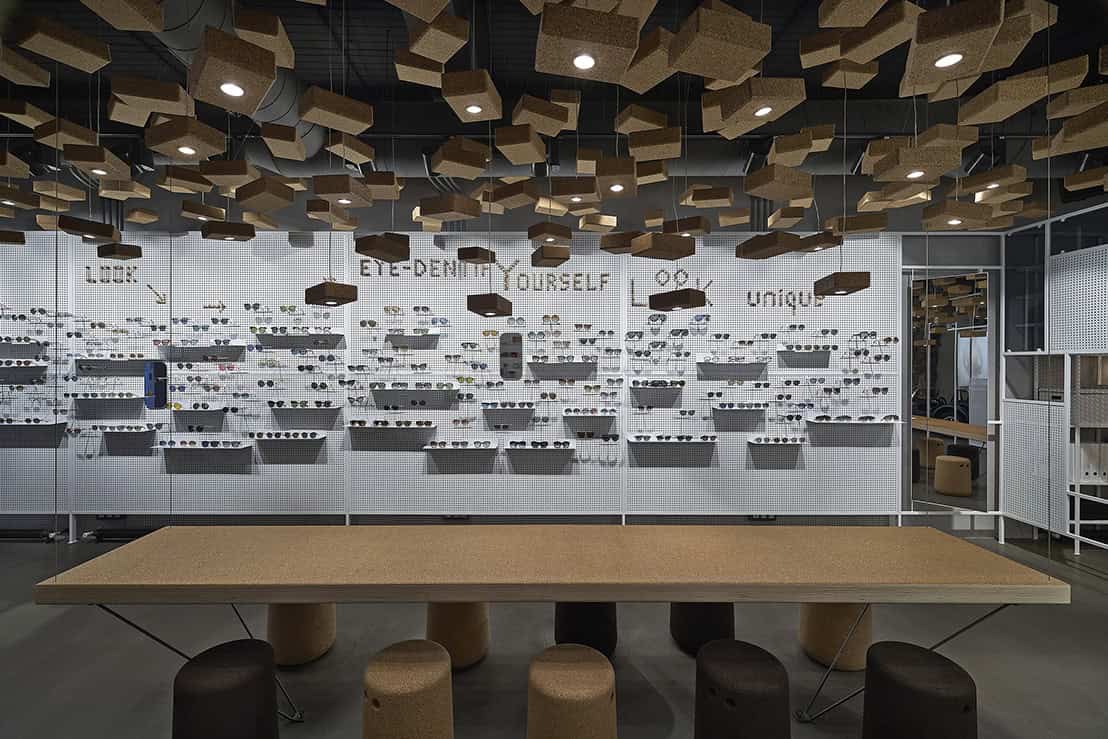 Eye glasses display wall with innovative shelving design, modern architecture art, and functional interior space in contemporary eyewear store.
