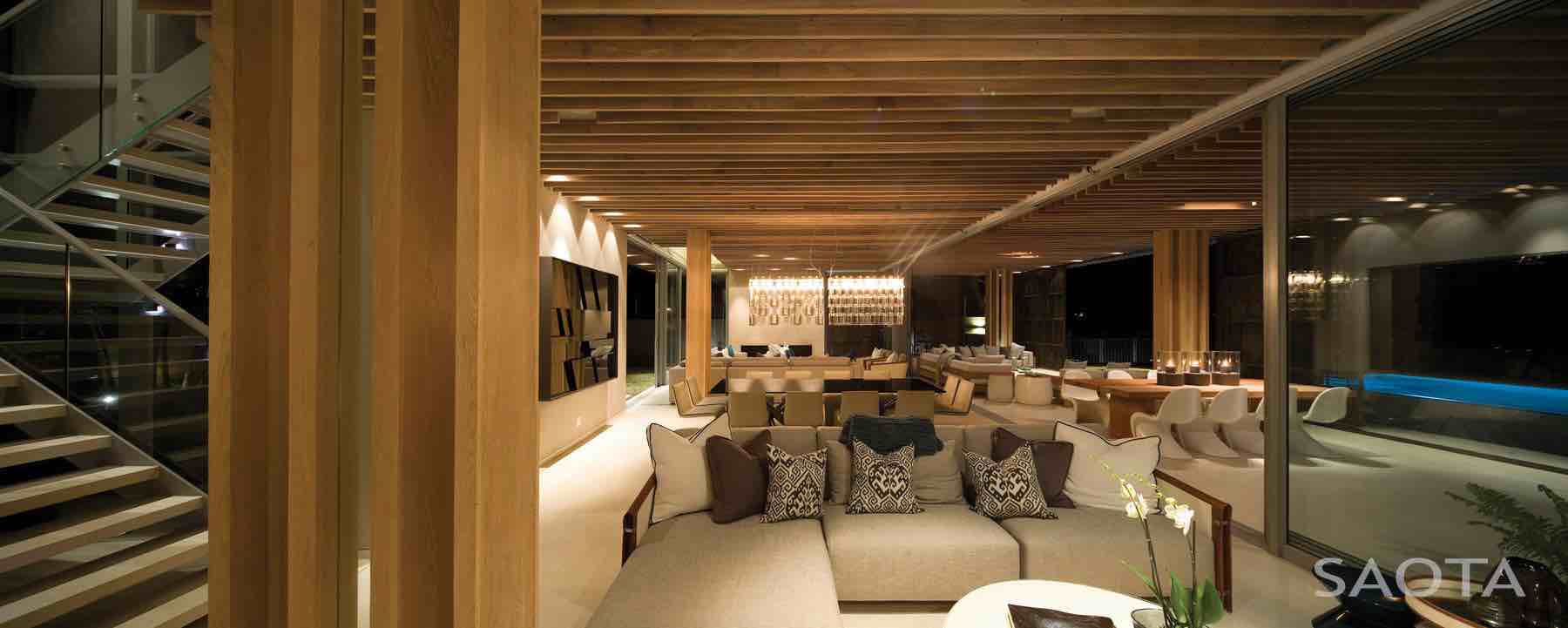 La Lucia — Indoor–outdoor continuity Open-plan living with large sliders connecting lounge and deck in La Lucia beach house.