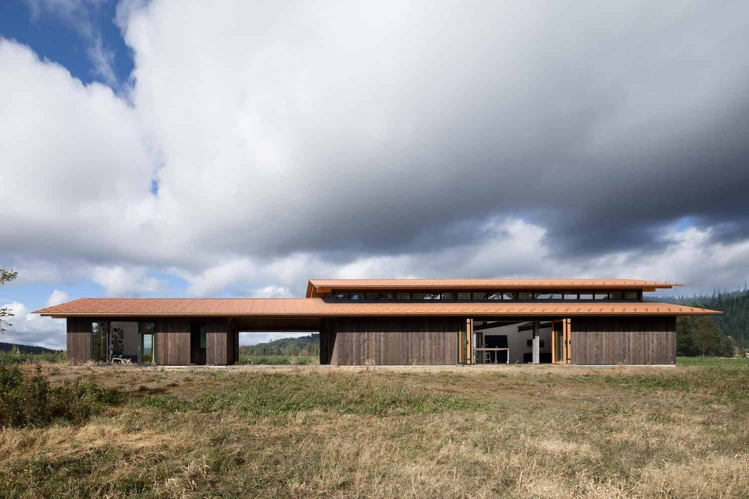 Contemporary wooden house with modern architecture design, large open spaces, and sustainable roofing in a scenic rural landscape. Perfect example of innovative and eco-friendly architecture.