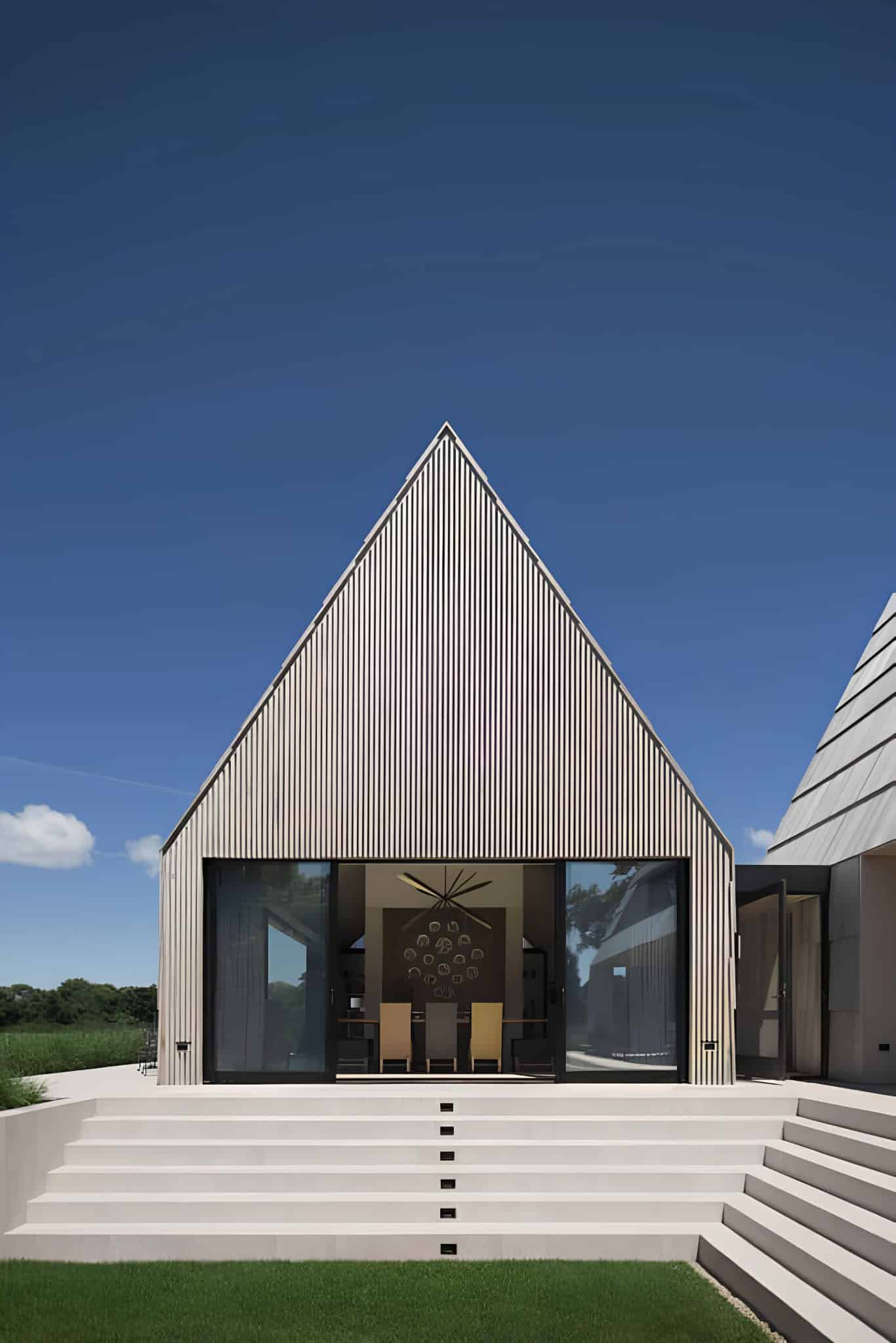 Gabled Dining Pavilion with Steps Contemporary gabled dining pavilion with steps leading to manicured lawn.