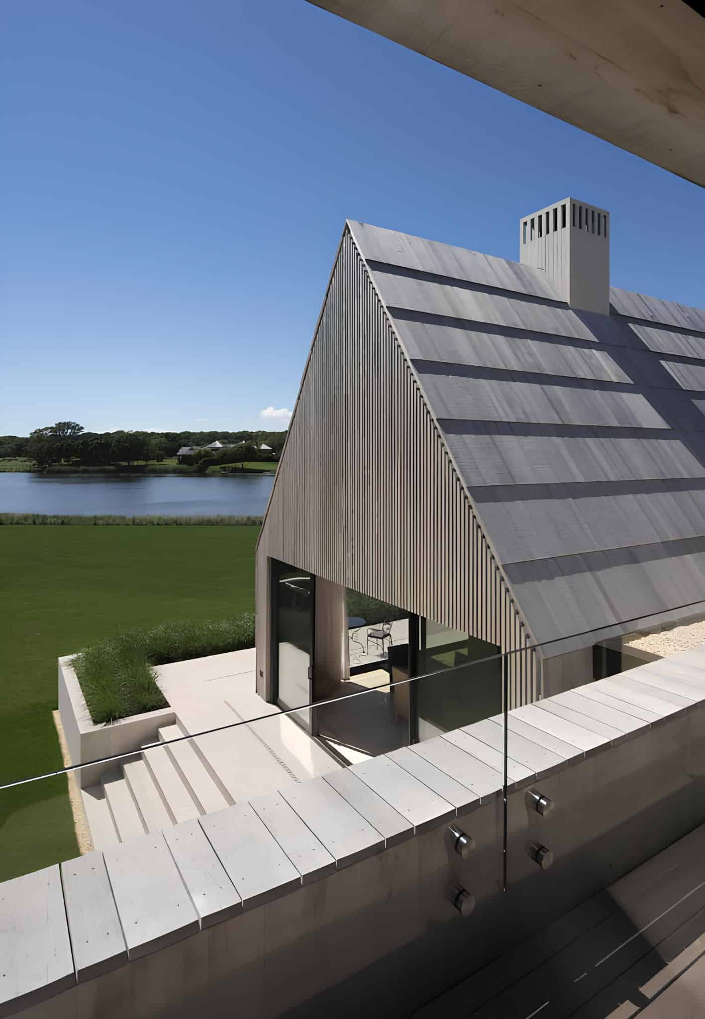 Gabled Structure Overlooking Waterfront Metal-clad gabled building overlooking a calm waterfront.