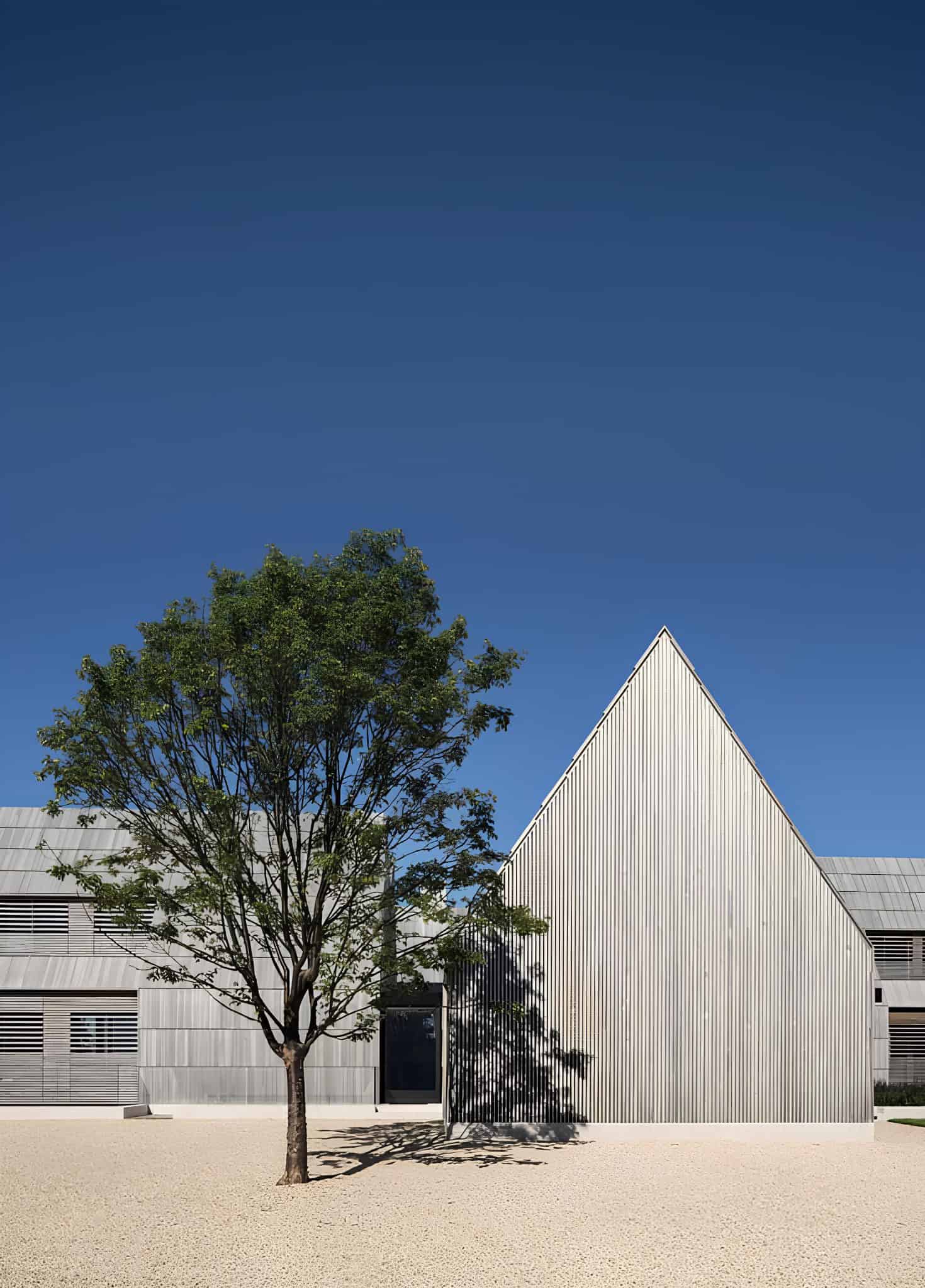 Georgica Cove Residence Front Facade Daylight Front daylight view of Georgica Cove Residence with minimalist landscaping.