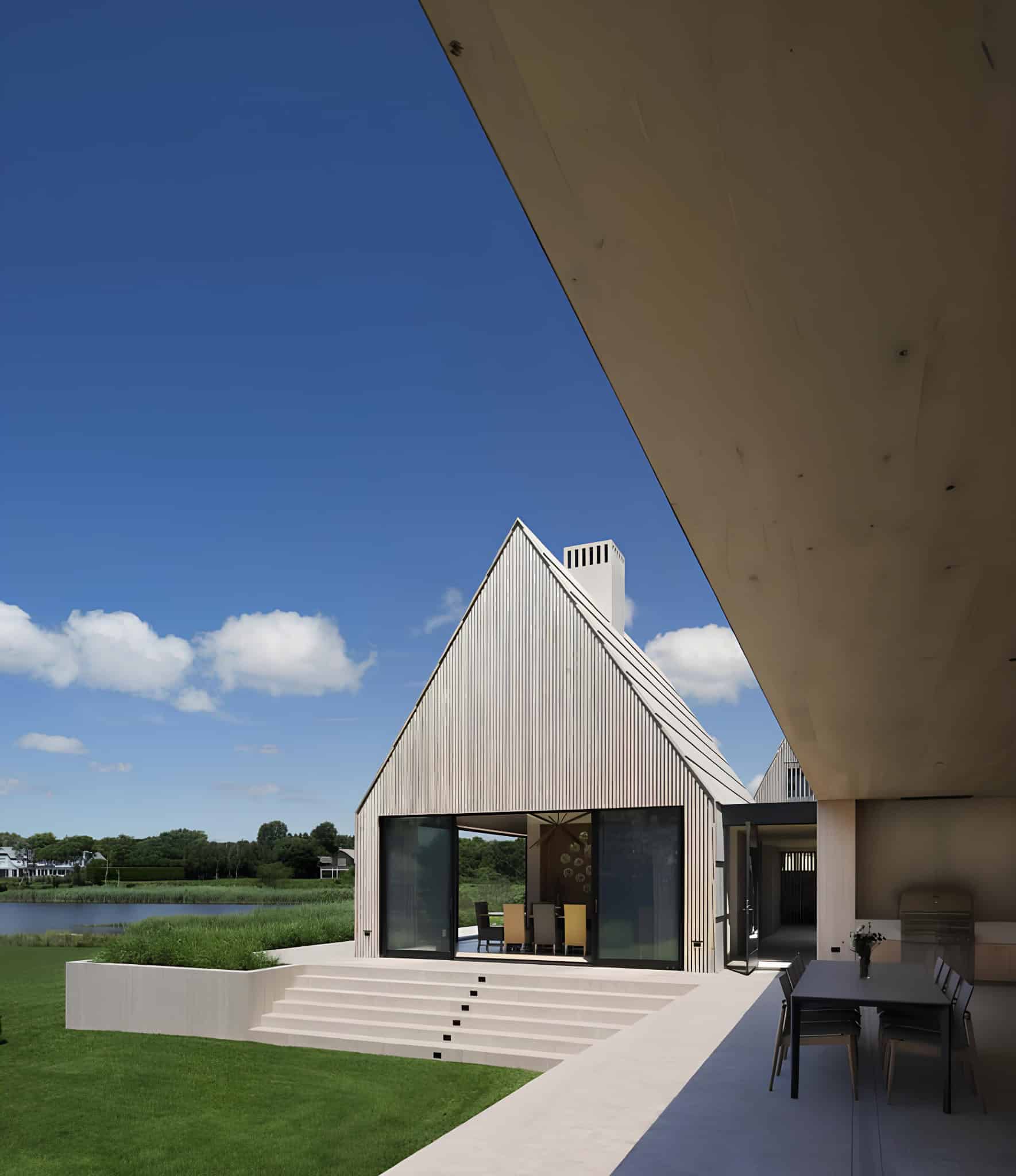 Modern Residence Gabled Roof and Pathway Gabled roof of a modern home with garden pathway and glass facade.