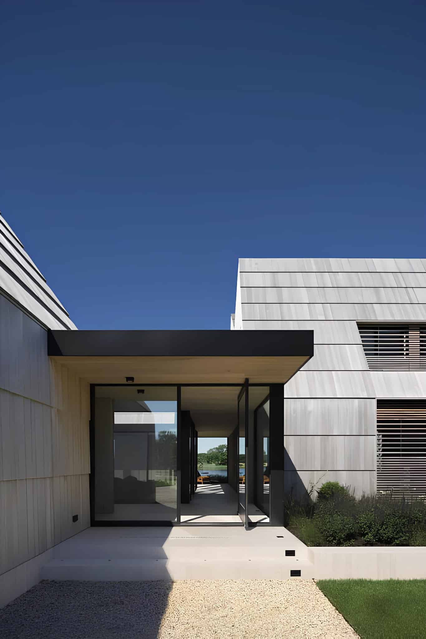 Vertical Gabled Facade and Tree Shadow Gabled structure with vertical siding and tree shadow cast on facade.