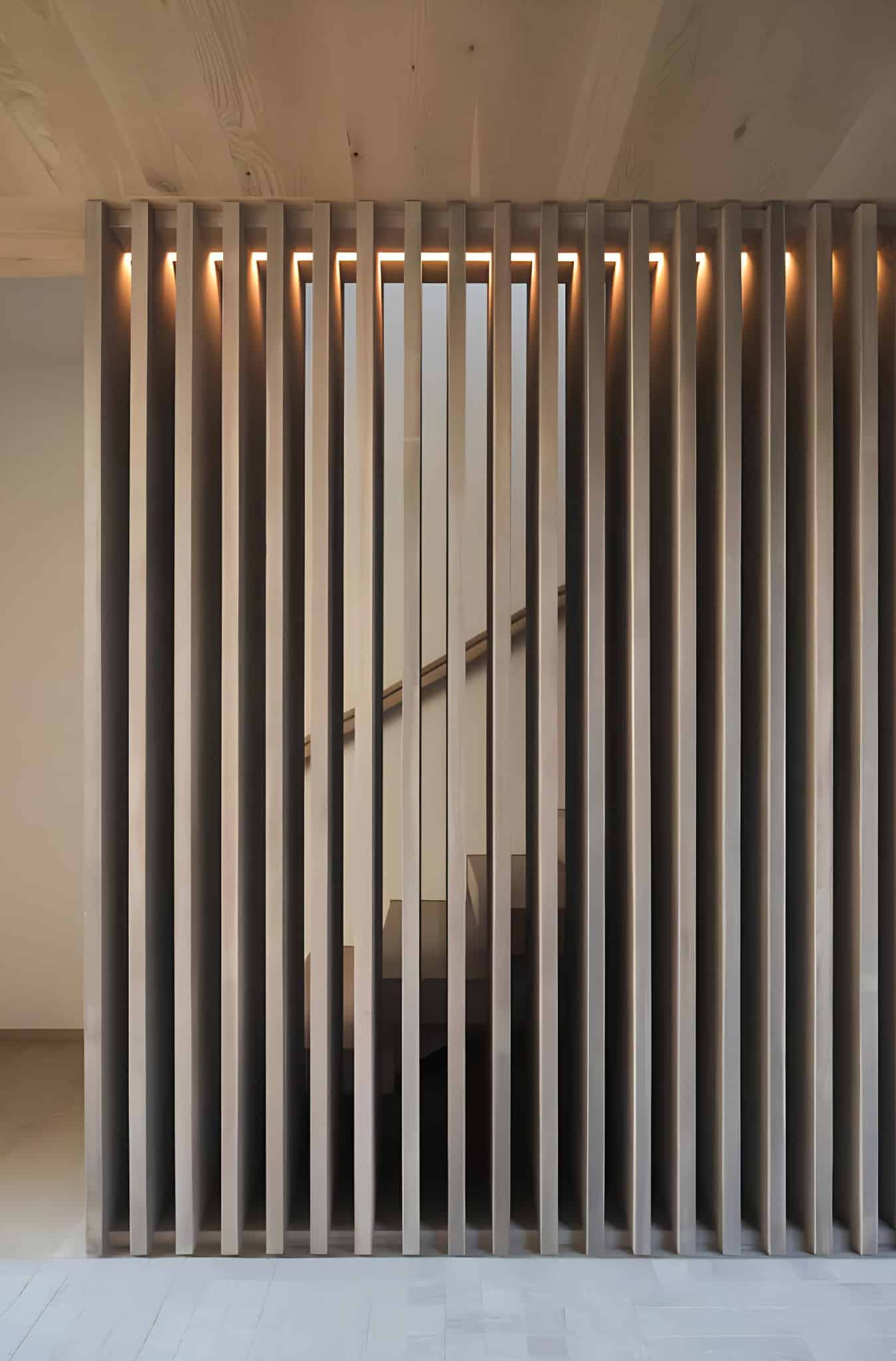 Vertical Slat Staircase Screen Lighting Vertical slat screen concealing staircase with accent lighting.