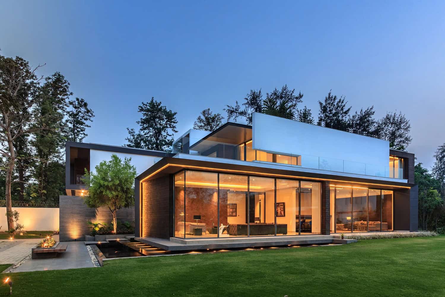 Modern house with glass walls and lawn