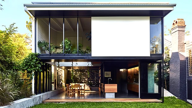 Modern two-story residential building with extensive glass facade and open-plan living area, showcasing contemporary architecture and innovative design.