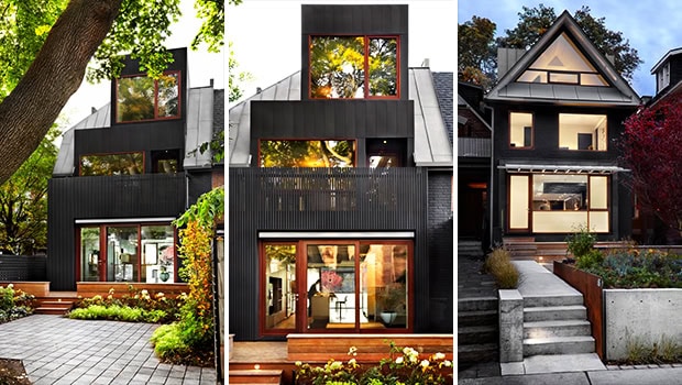 Modern black residential house with large windows and contemporary architecture, surrounded by lush greenery.
