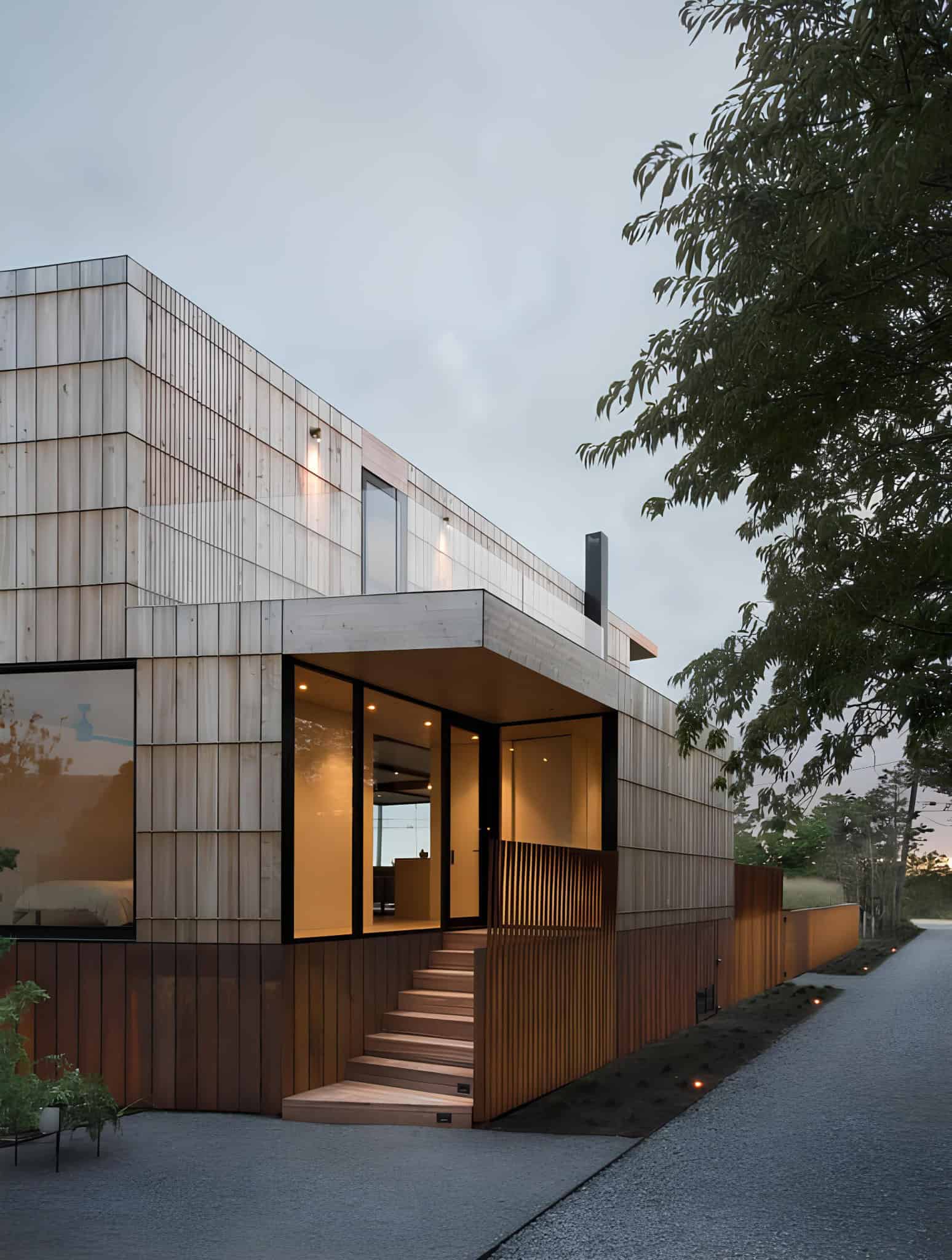 Atlantic House Evening Entry and Staircase Entry to Atlantic House illuminated at dusk with wood cladding and staircase.