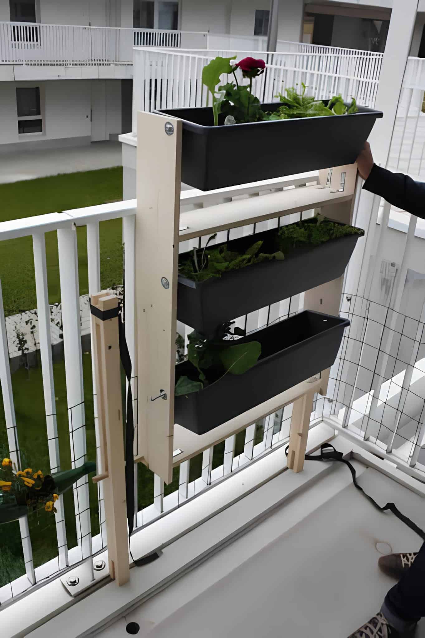 Slim vertical planter for balconies with black rectangular pots