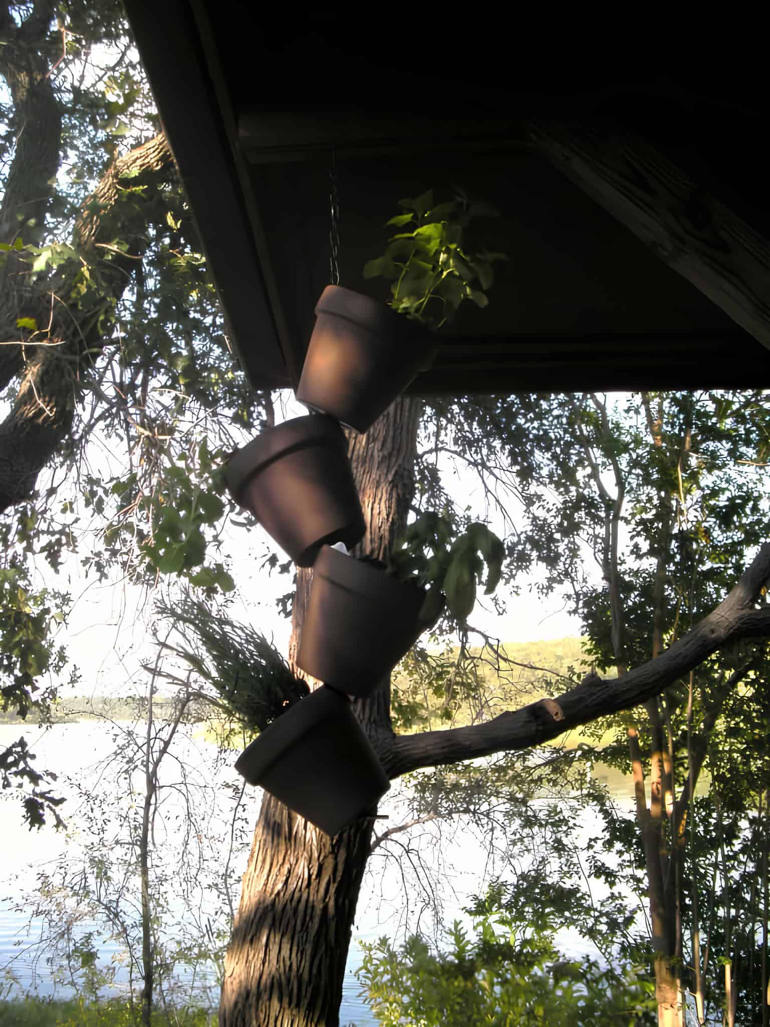 Hanging vertical garden made from pots suspended on a chain