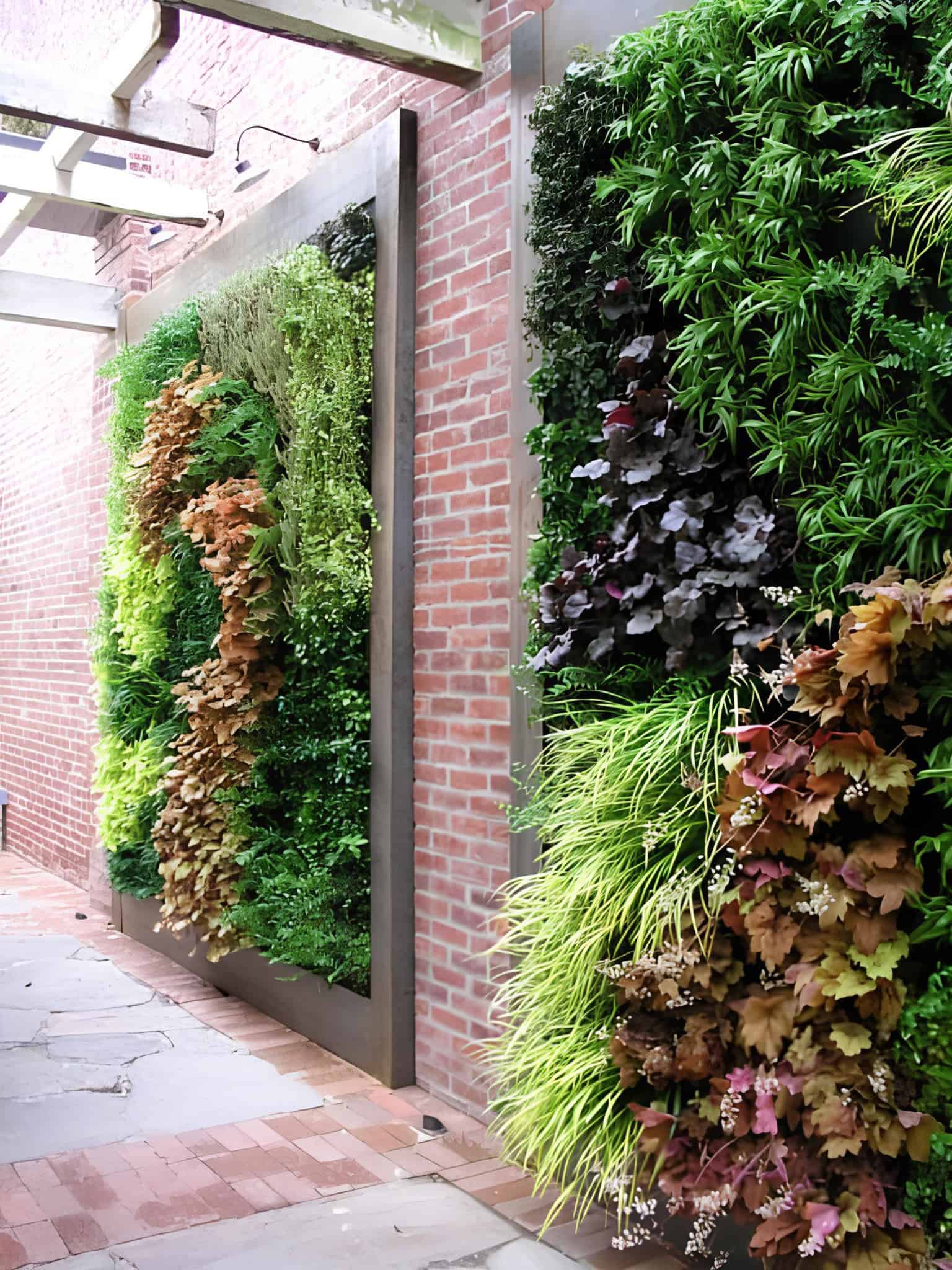 Dramatic plant wall with texture and color on urban brick facade