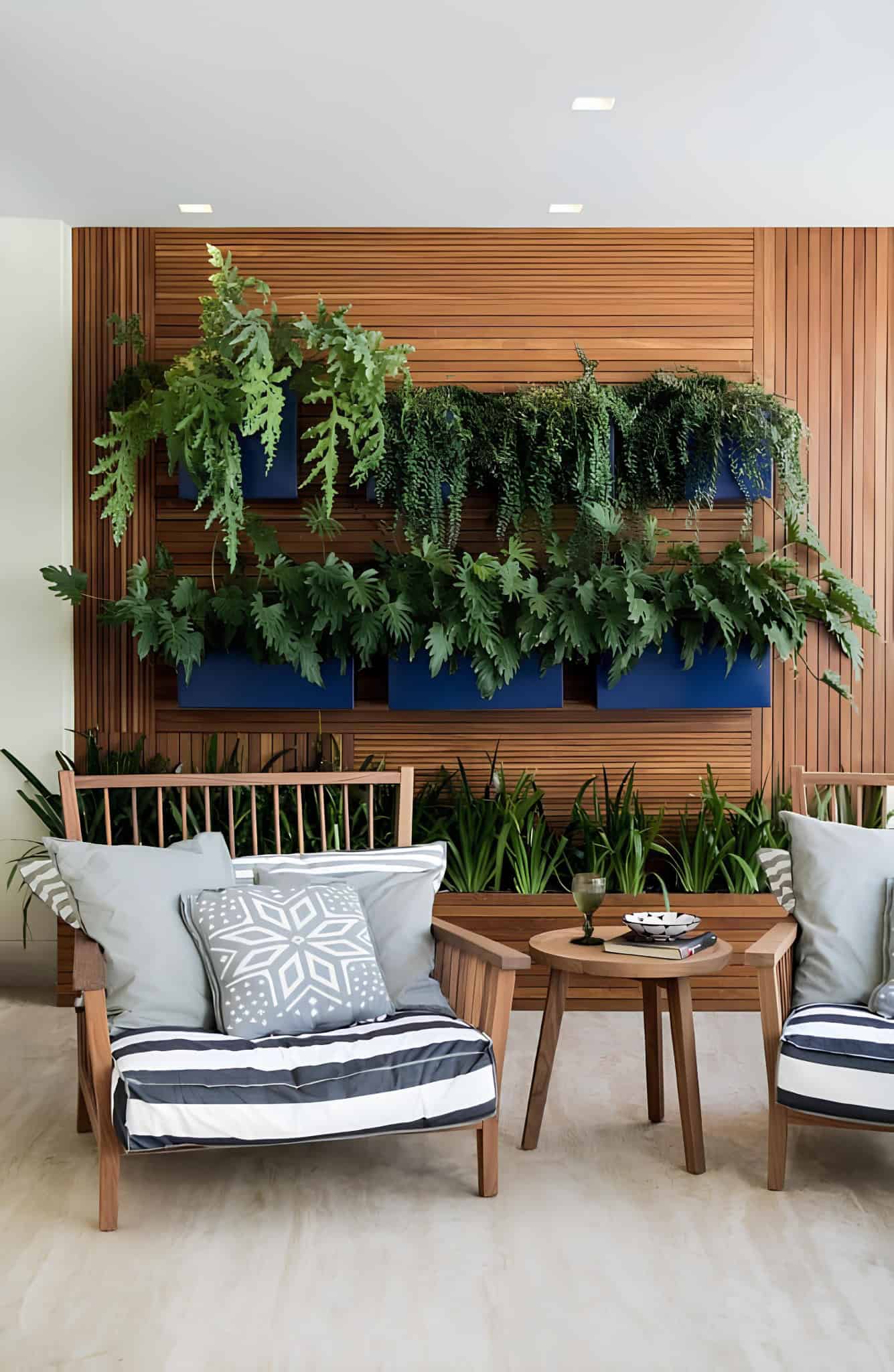 Vibrant green indoor plant wall in white living room with modern decor