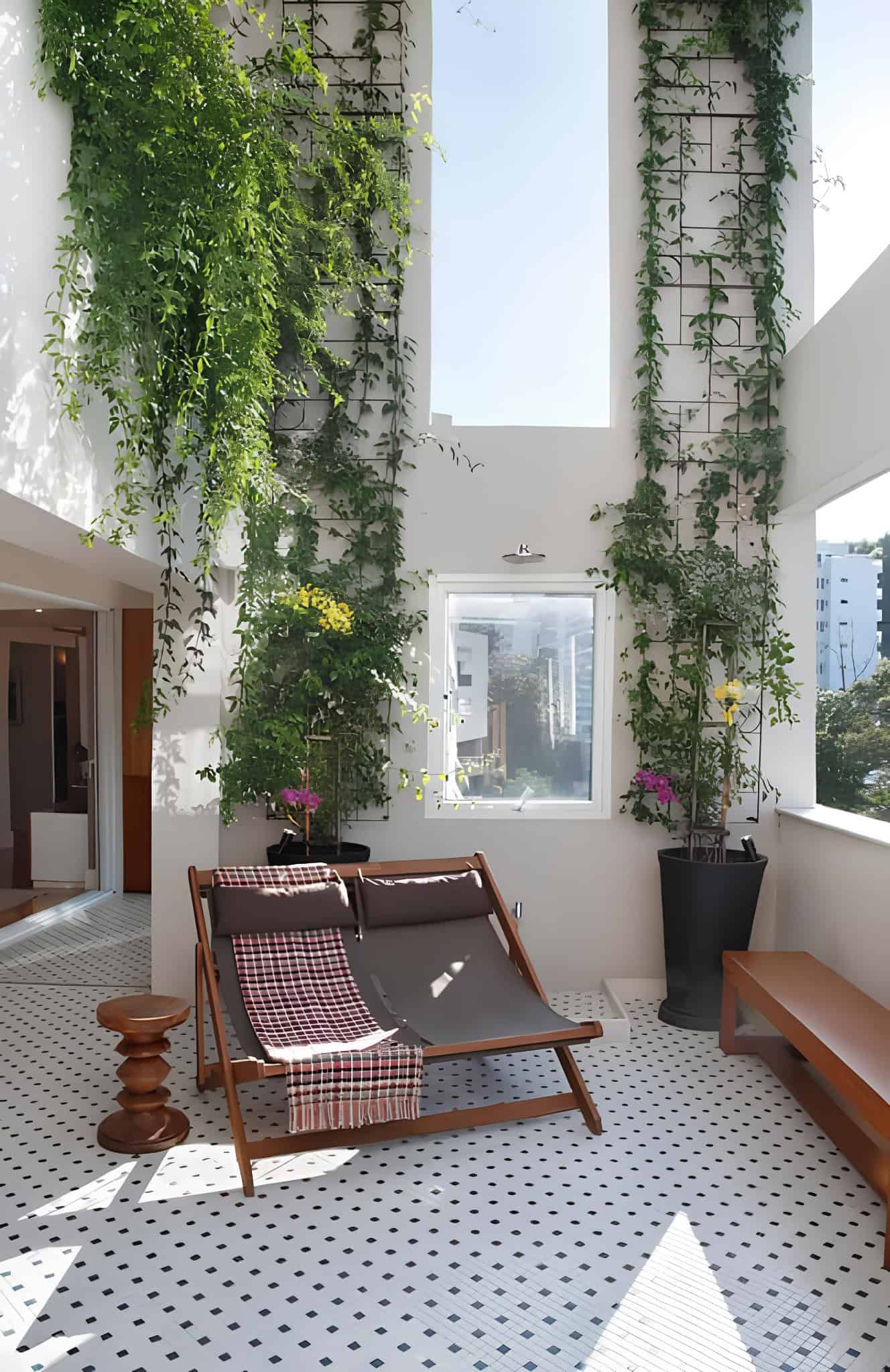 Wooden trellis structure with hanging orchid planters on balcony