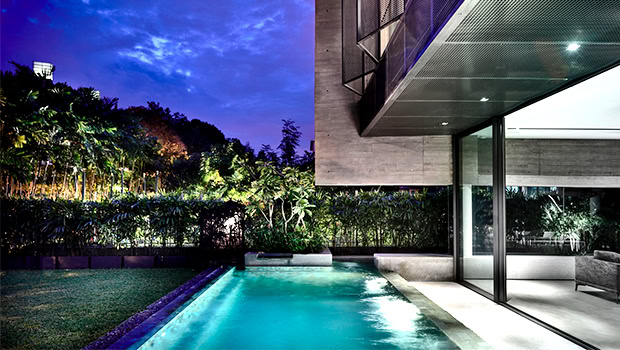 Modern luxury house with indoor and outdoor swimming pool, contemporary architecture, glass walls, and sleek design.