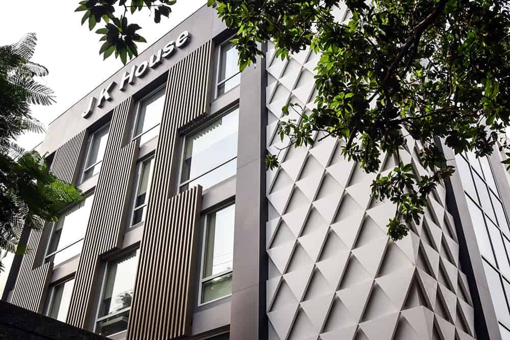 Modern commercial building with sleek architectural design and artistic exterior facade, showcasing innovative architecture art for contemporary urban spaces.