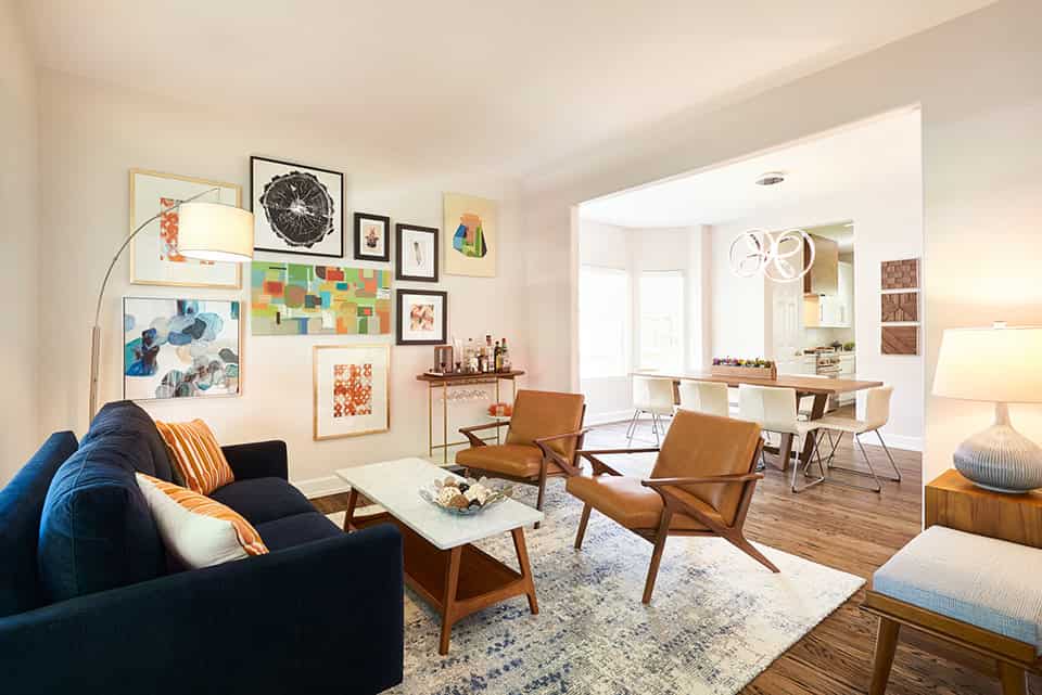 Bright and modern living room interior with contemporary furniture and eclectic artwork, showcasing stylish home decor ideas for open-concept apartments.